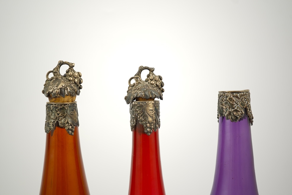 A composed set of six mid 19th century vari-coloured glass carafes